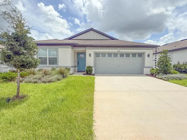 a front view of house with yard and green space