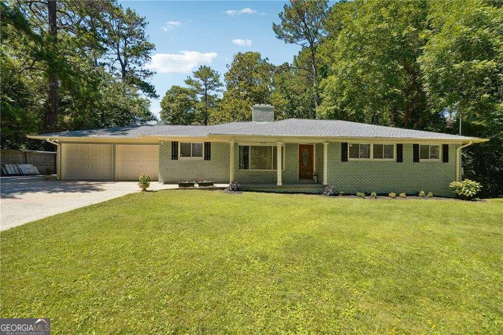 1192 Eastridge Road Southwest Atlanta, GA 30311 - Photo 1 of 1 a front view of a house with a garden
