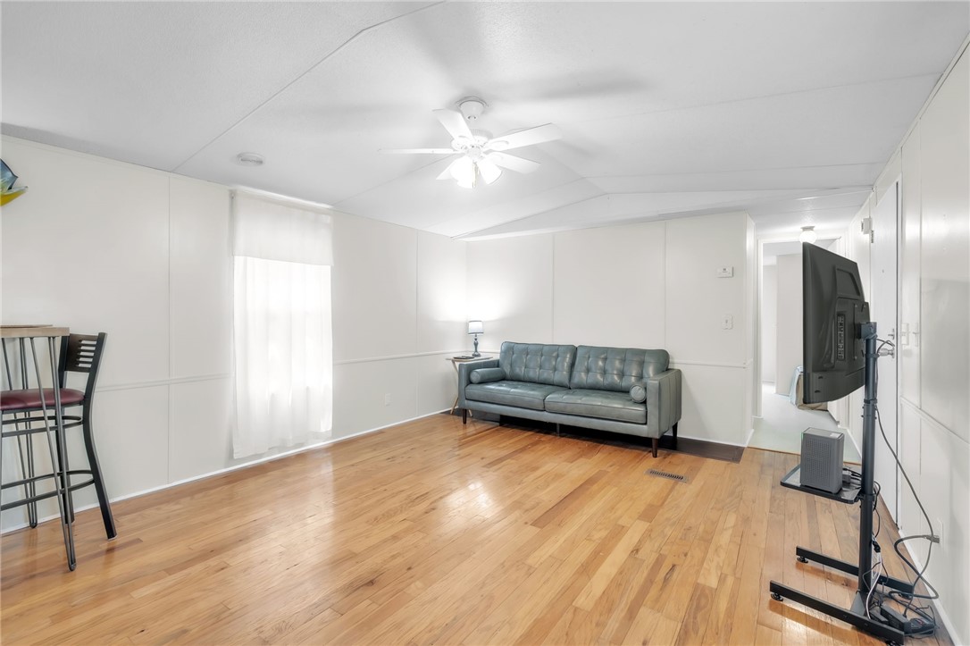 506 Charlies Creek Road Iva, SC 29655 - Photo 7 of 28 Natural light illuminates the smooth hardwood flooring in this versatile living space.