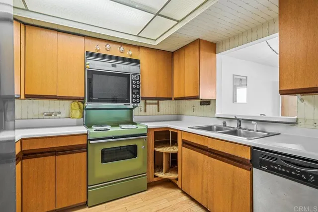a kitchen with a sink stove and microwave