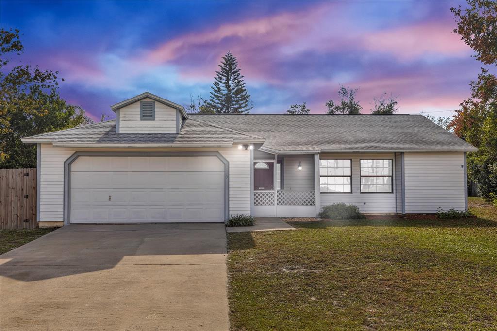 2405 Kerridale Street Deltona, FL 32738 - Photo 1 of 1 a front view of a house with a yard and garage