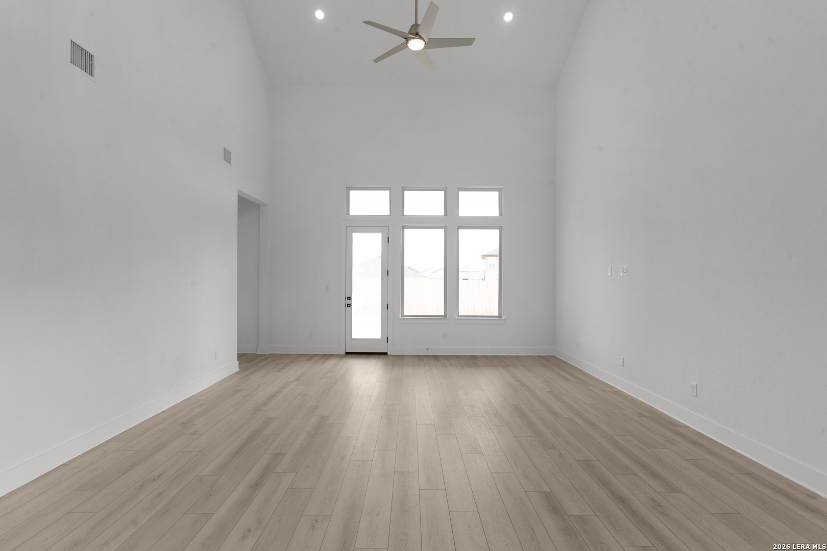 940 Nolte Bend Seguin, TX 78155 - Photo 9 of 19 a view of an empty room with wooden floor and a window