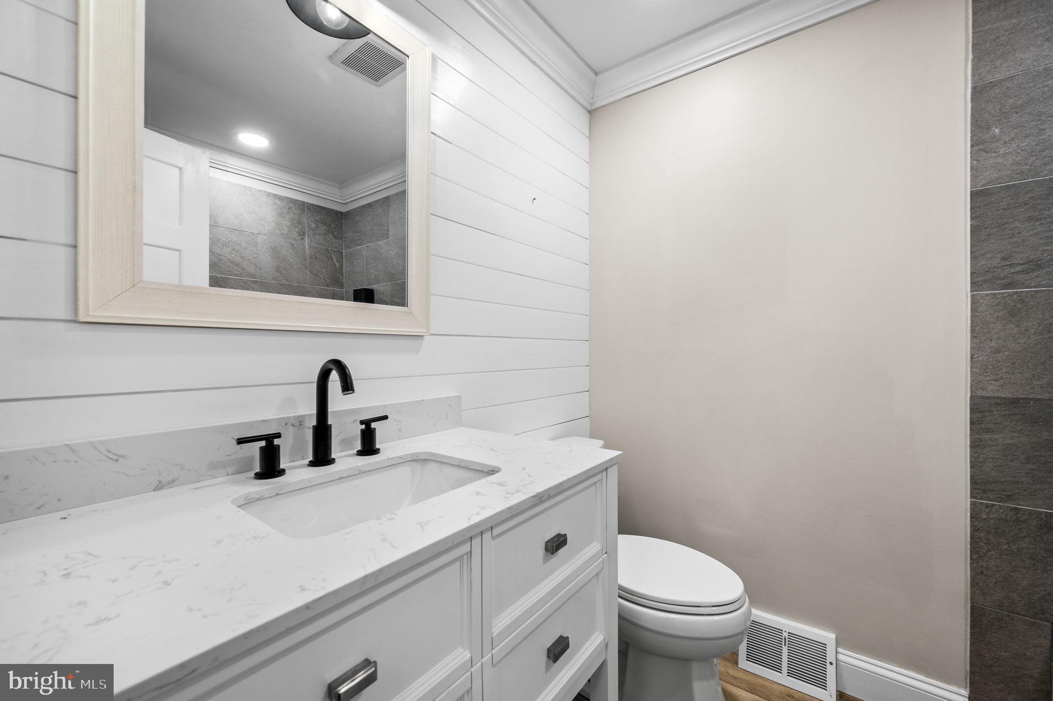 43 Gunning Lane, Unit 12 Downingtown, PA 19335 - Photo 12 of 19 a bathroom with a toilet a sink and mirror