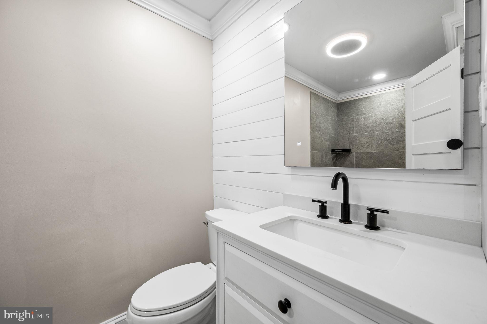43 Gunning Lane, Unit 12 Downingtown, PA 19335 - Photo 16 of 19 a bathroom with a sink a toilet and mirror
