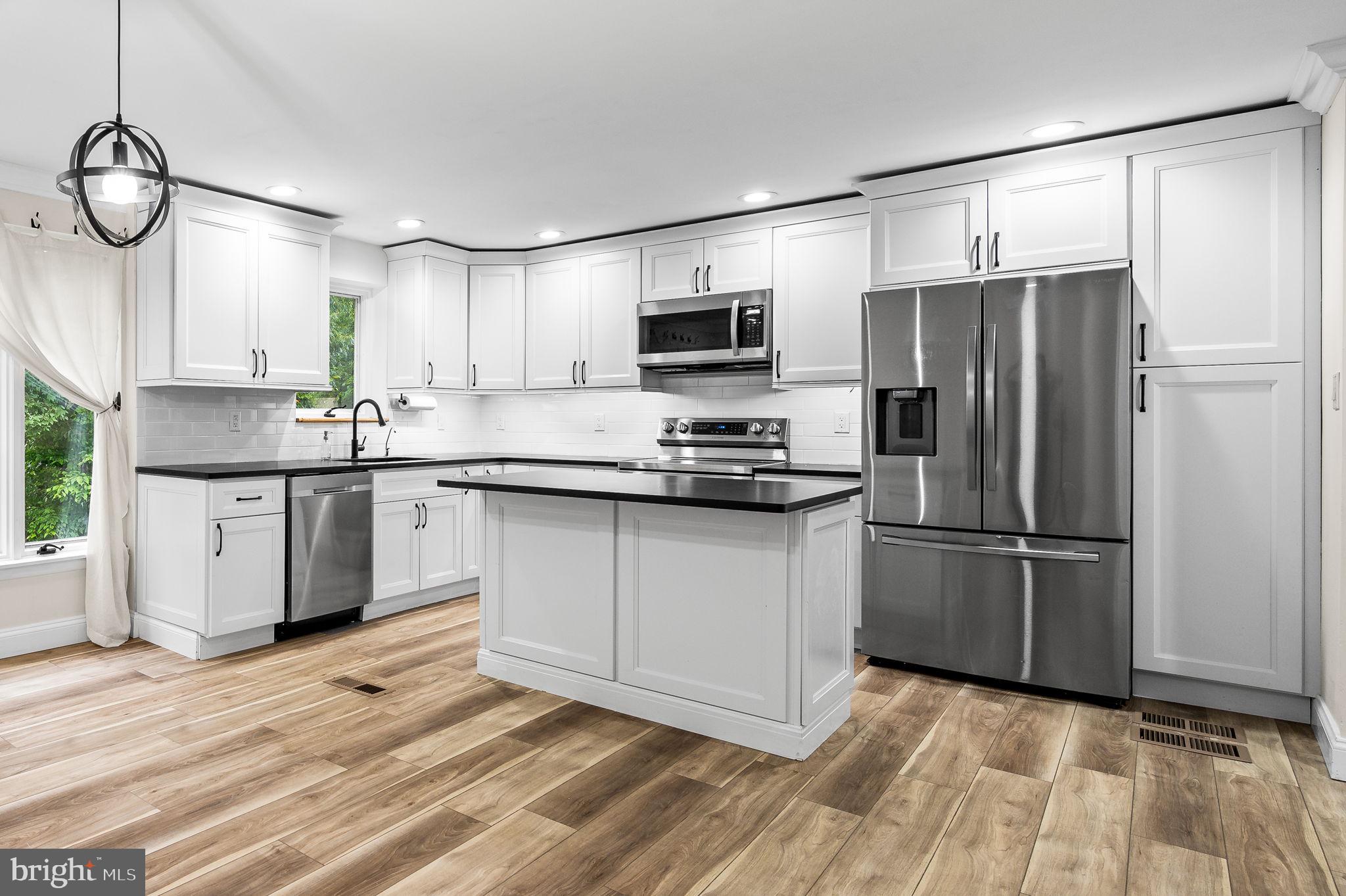 43 Gunning Lane, Unit 12 Downingtown, PA 19335 - Photo 5 of 19 a kitchen with stainless steel appliances a refrigerator sink and microwave
