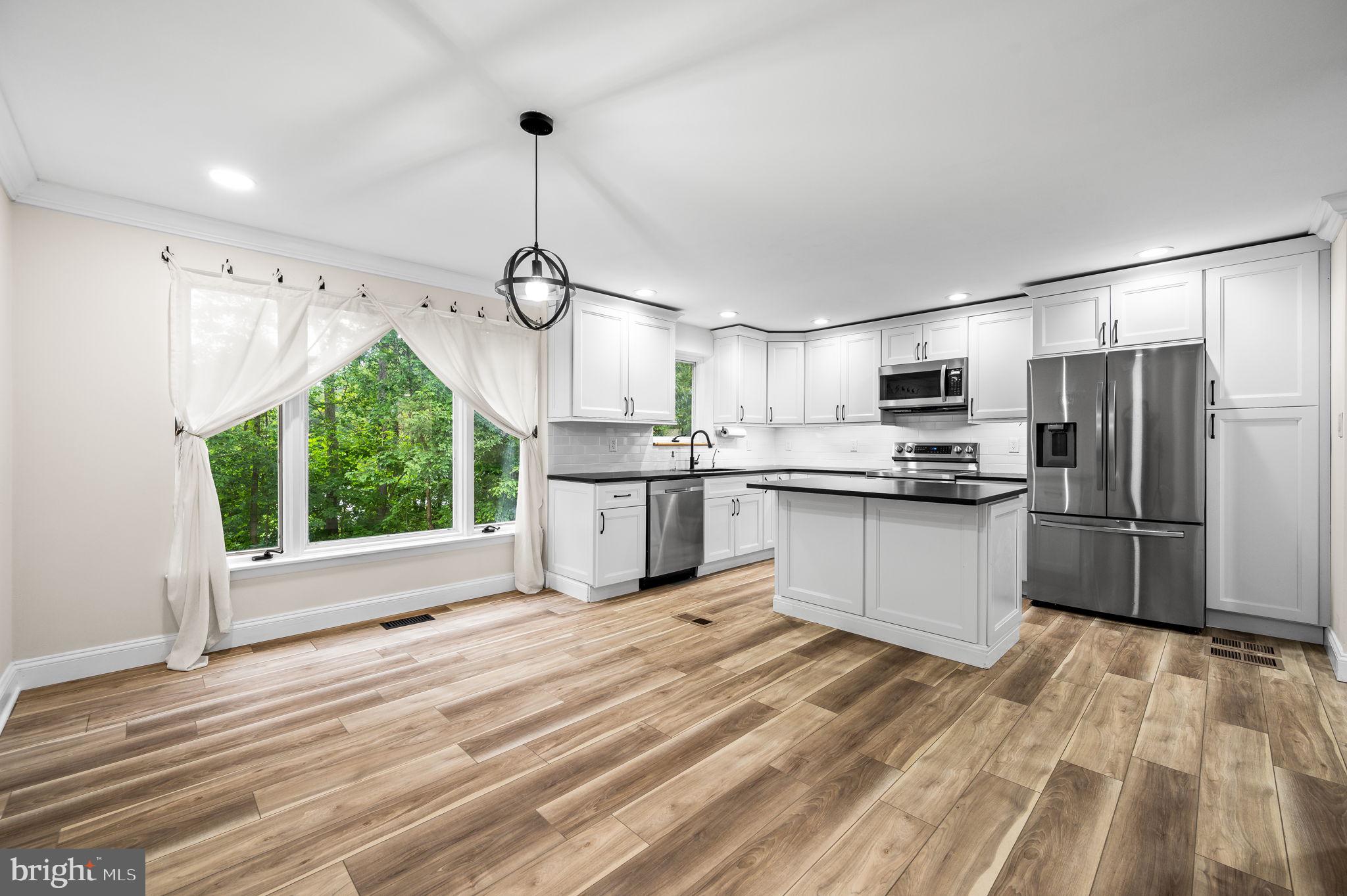 43 Gunning Lane, Unit 12 Downingtown, PA 19335 - Photo 6 of 19 a kitchen with stainless steel appliances granite countertop a refrigerator and a sink