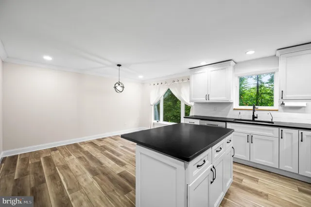 a kitchen that has a sink and a stove in it