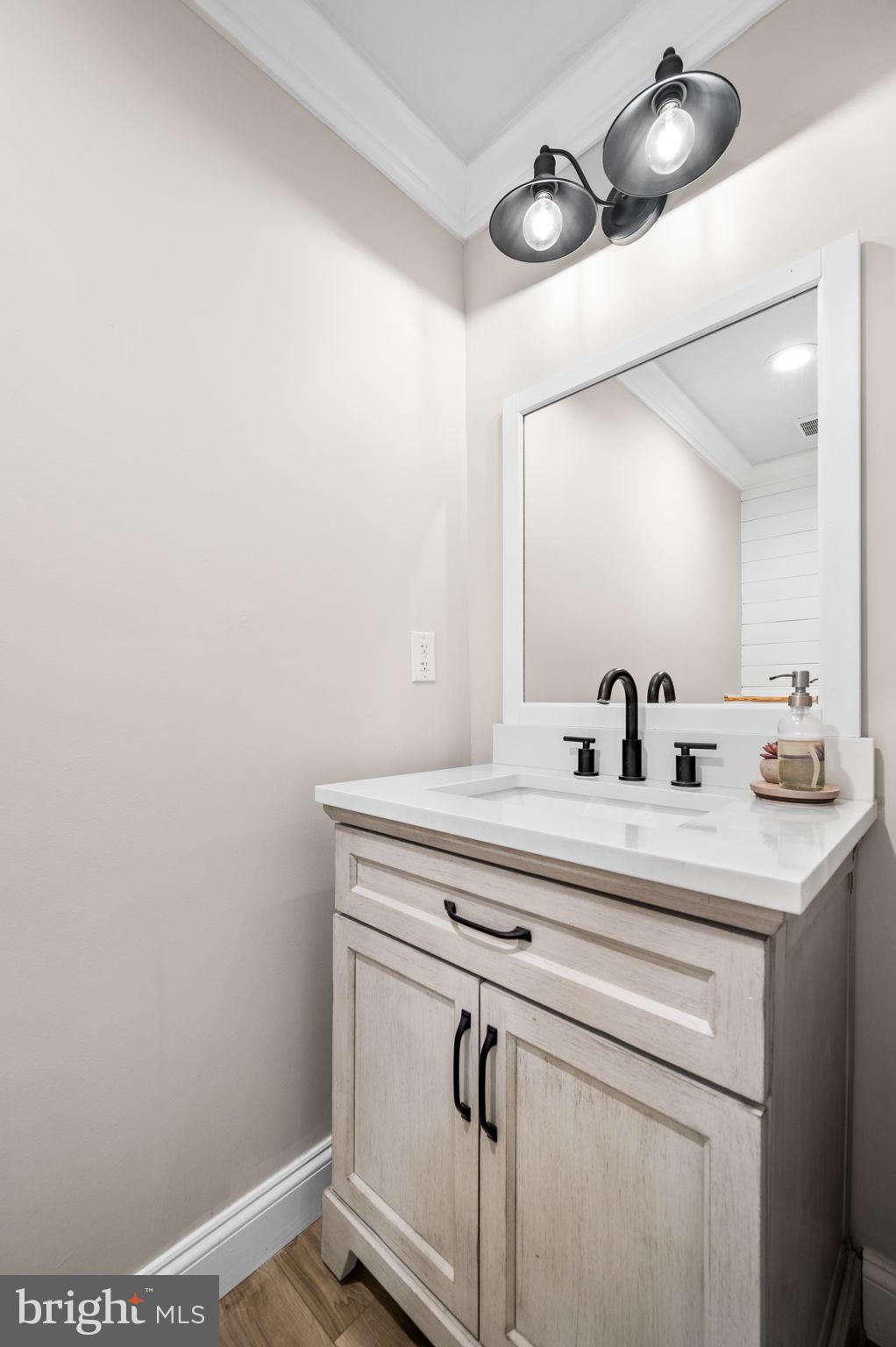 43 Gunning Lane, Unit 12 Downingtown, PA 19335 - Photo 8 of 19 a bathroom with a sink and mirror