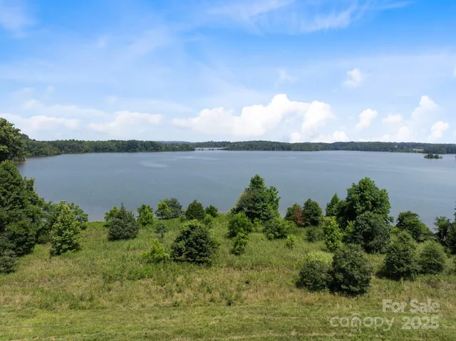 a view of a field with an trees in the background