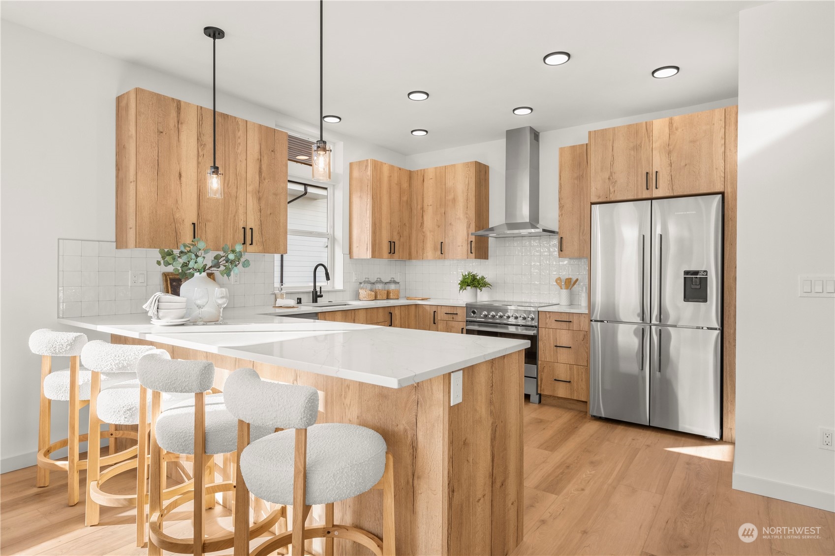 508 North 48th Street Seattle, WA 98103 - Photo 11 of 38 a kitchen with kitchen island a refrigerator a stove a sink and chairs