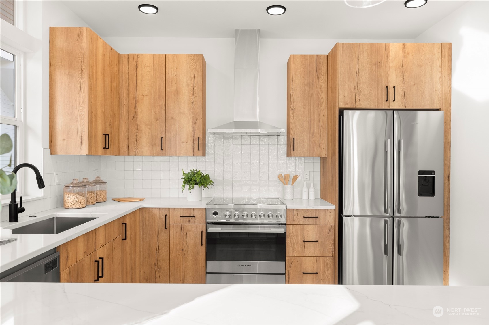 508 North 48th Street Seattle, WA 98103 - Photo 12 of 38 a kitchen with stainless steel appliances a refrigerator sink and cabinets
