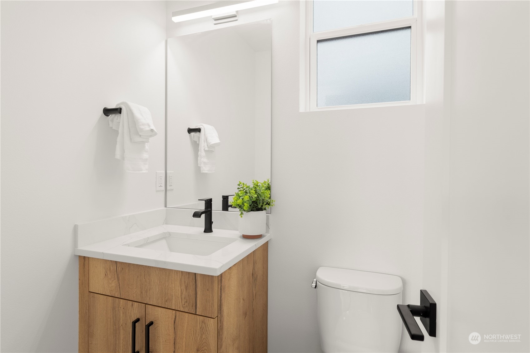 508 North 48th Street Seattle, WA 98103 - Photo 19 of 38 a bathroom with a sink and a mirror