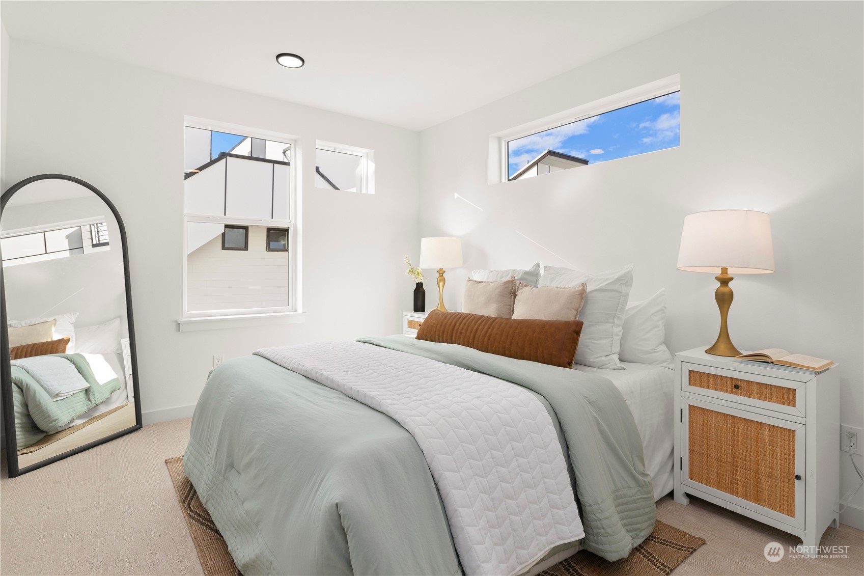 508 North 48th Street Seattle, WA 98103 - Photo 23 of 38 a bedroom with a bed a mirror and a chandelier