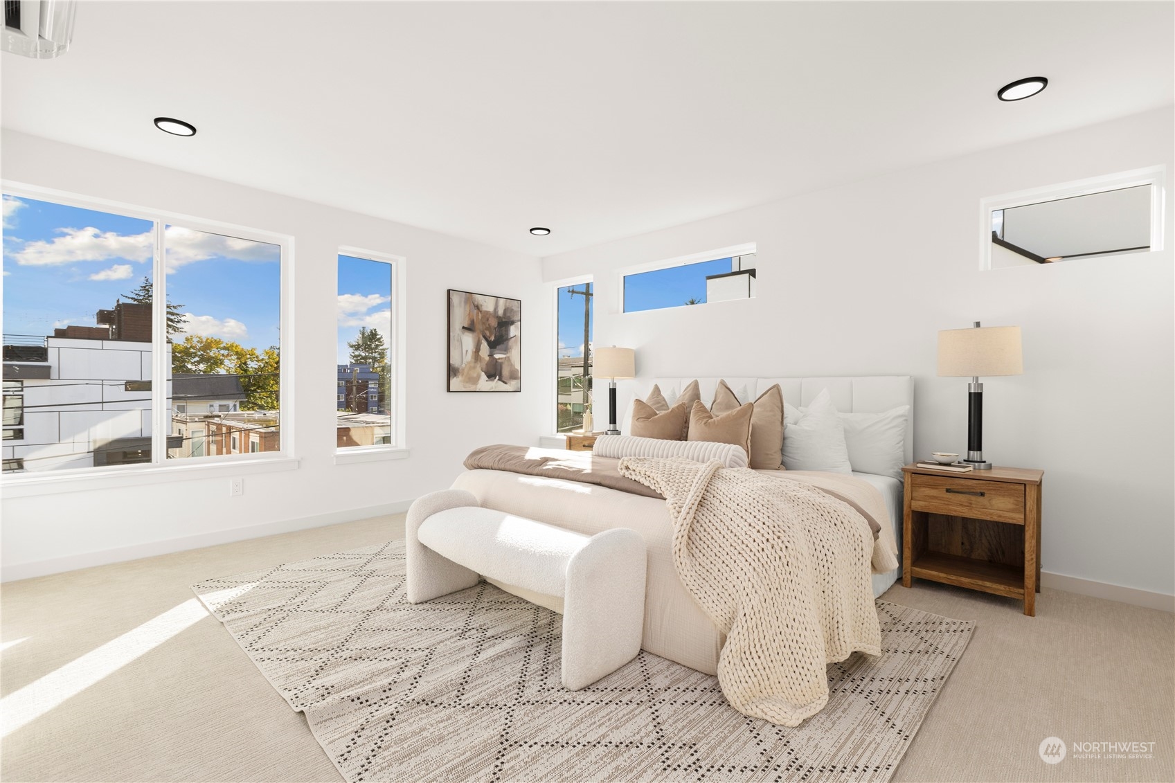508 North 48th Street Seattle, WA 98103 - Photo 27 of 38 a spacious bedroom with a bed and glass windows