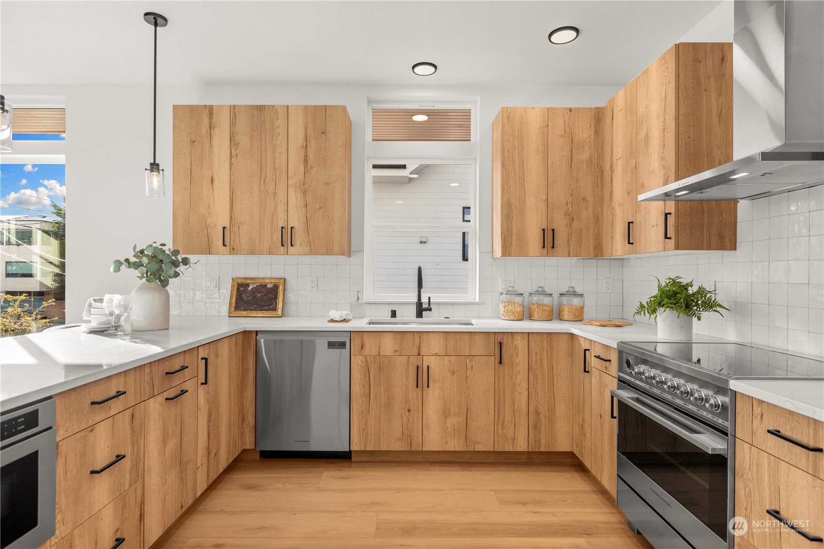508 North 48th Street Seattle, WA 98103 - Photo 10 of 38 a large kitchen with stainless steel appliances sink a stove and cabinets