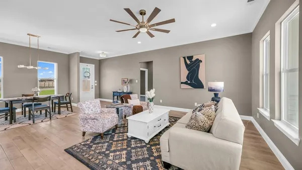 a living room with furniture and kitchen view