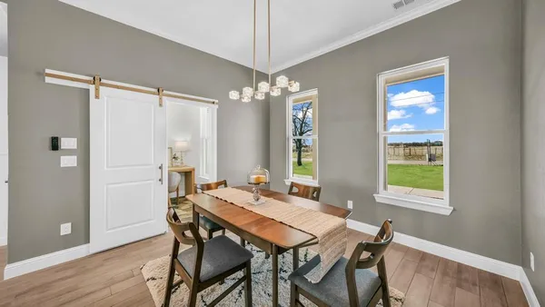a view of a dining room with furniture window and wooden floor