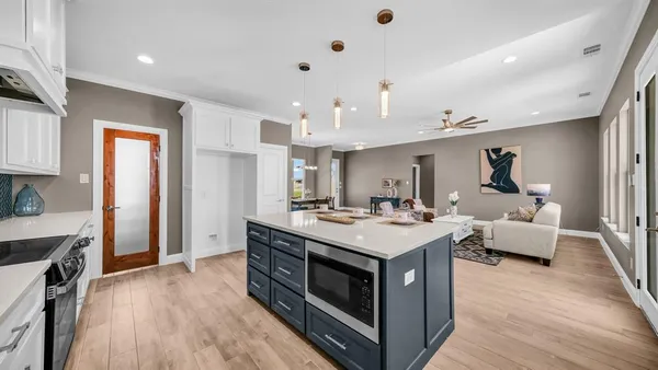 a kitchen with stainless steel appliances granite countertop a sink a stove and a refrigerator