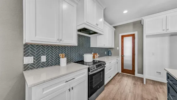 a open kitchen with stainless steel appliances granite countertop a lot of counter space and wooden floors