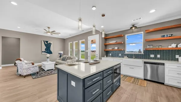 a kitchen with cabinets and a wooden floor