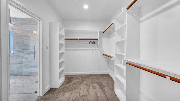 a view of an empty room with window and closet area