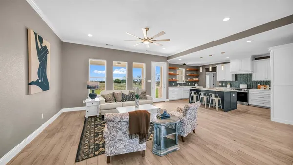 a living room with furniture fireplace and wooden floor