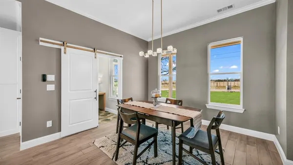 a view of a dining room with furniture window and wooden floor