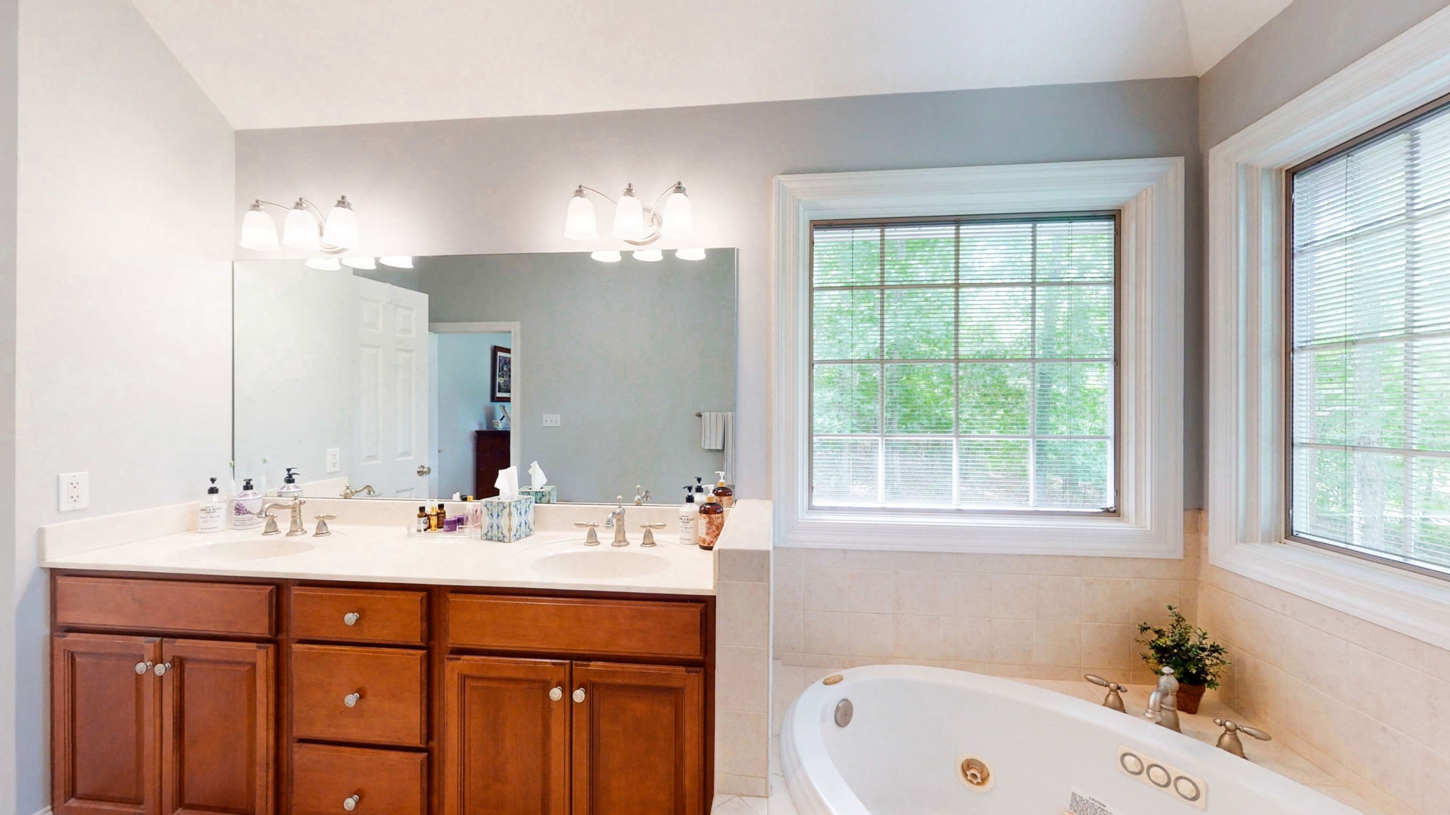 409 Legends Drive Springville, TN 38256 - Photo 18 of 51 a bathroom with a sink tub double vanity and a window