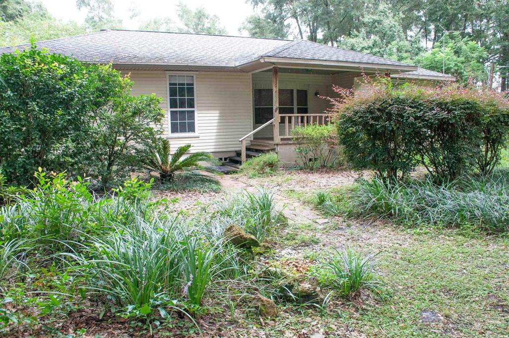 708 Southwest Fielding Way Fort White, FL 32038 - Photo 1 of 1 a front view of a house with garden