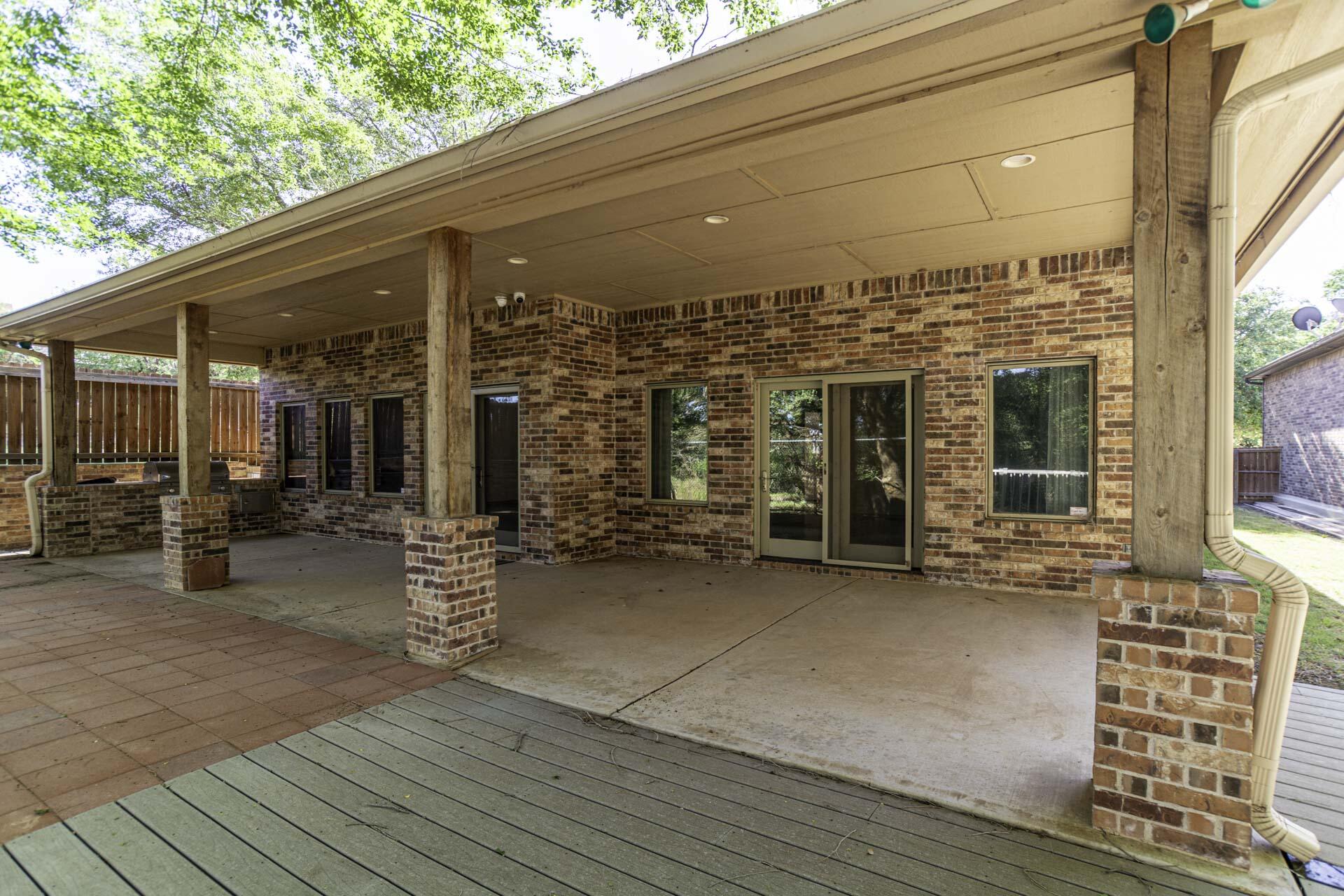 33 West Lakeshore Drive Ransom Canyon, TX 79366 - Photo 6 of 48 a view of a patio with table and chairs and wooden floor