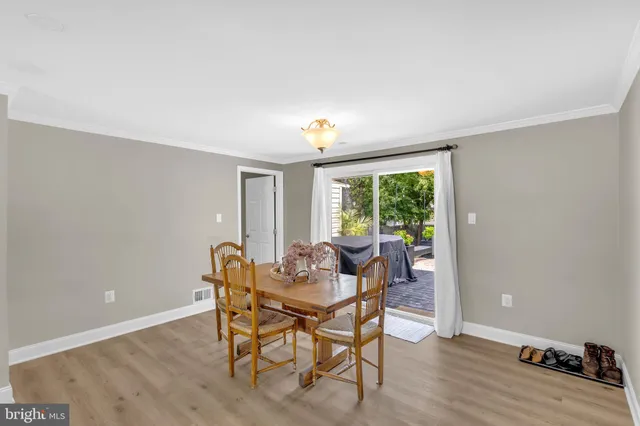 a dining room with furniture and wooden floor