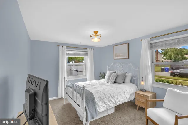 a bedroom with a bed and a chair