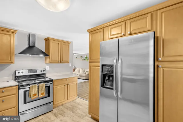 a kitchen with a refrigerator a stove and a sink