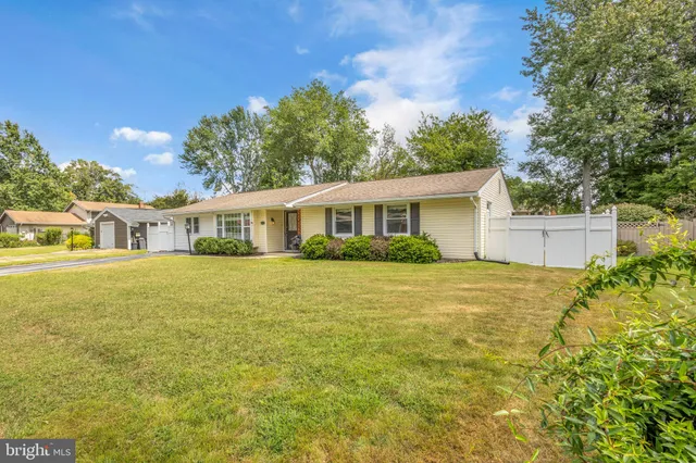 a view of an house with backyard and sitting area