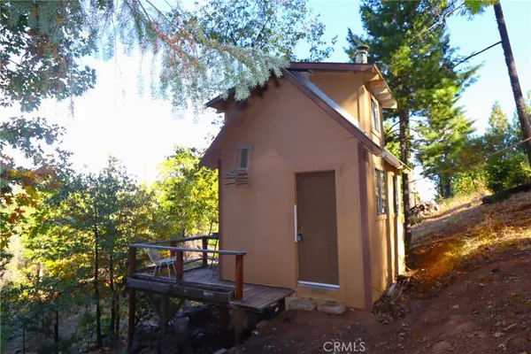 a backyard of a house with table and chairs