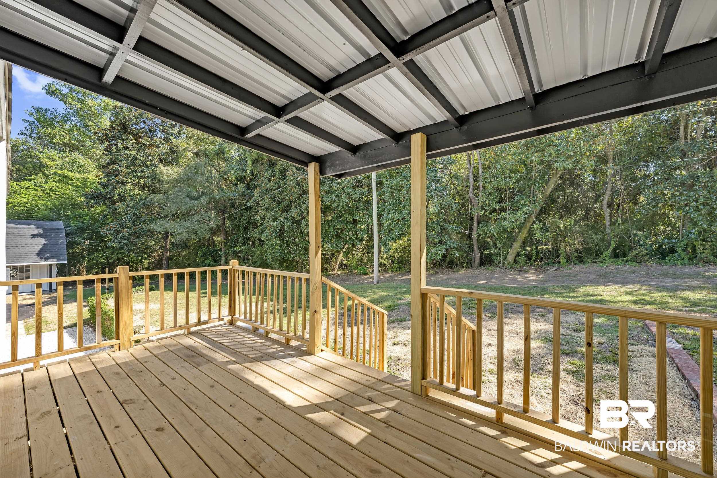 8351 Theodore Dawes Road Theodore, AL 36582 - Photo 6 of 46 Wooden terrace featuring view of scattered trees