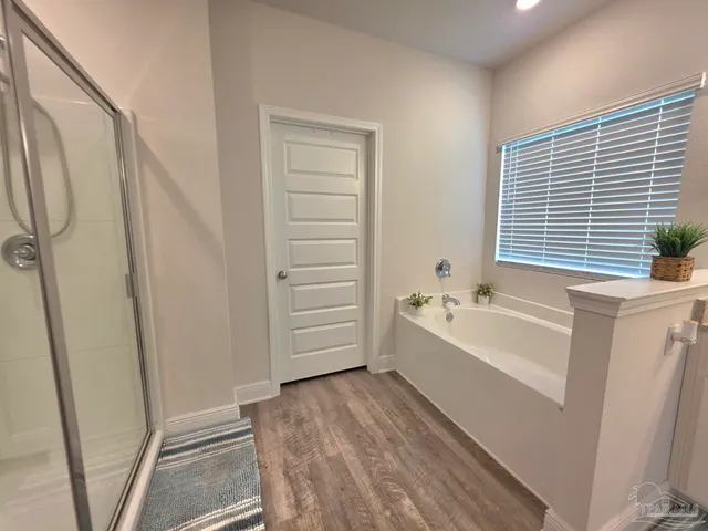 a bathroom with a bathtub a toilet and a shower