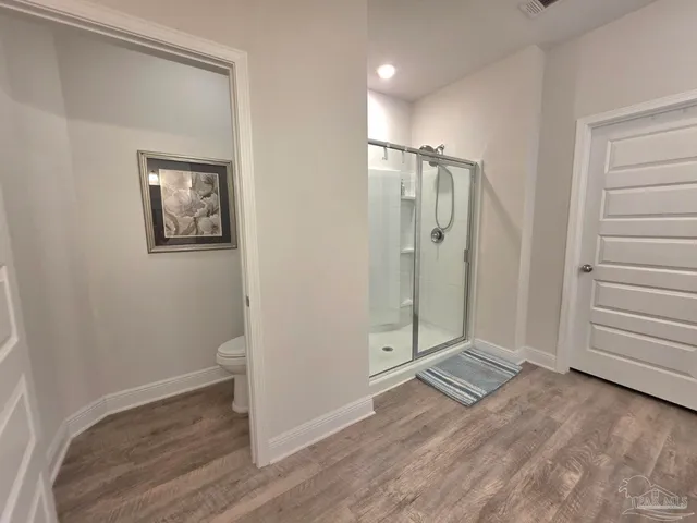 a view of a bathroom with wooden floor