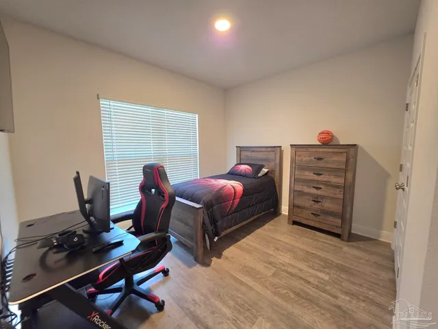 a bedroom with a bed and a desk