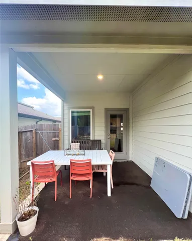 a living room with furniture a window and a potted plant