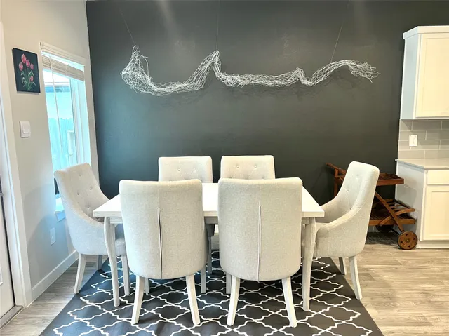 a view of a dining room with furniture and chandelier