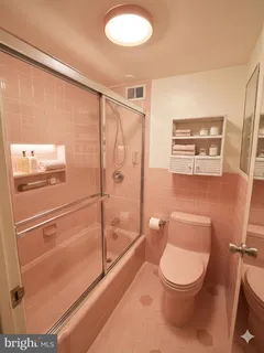 a bathroom with a toilet a sink and shower