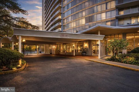 a view of a building with car parked