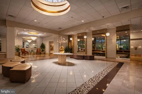 a lobby with furniture and a potted plant