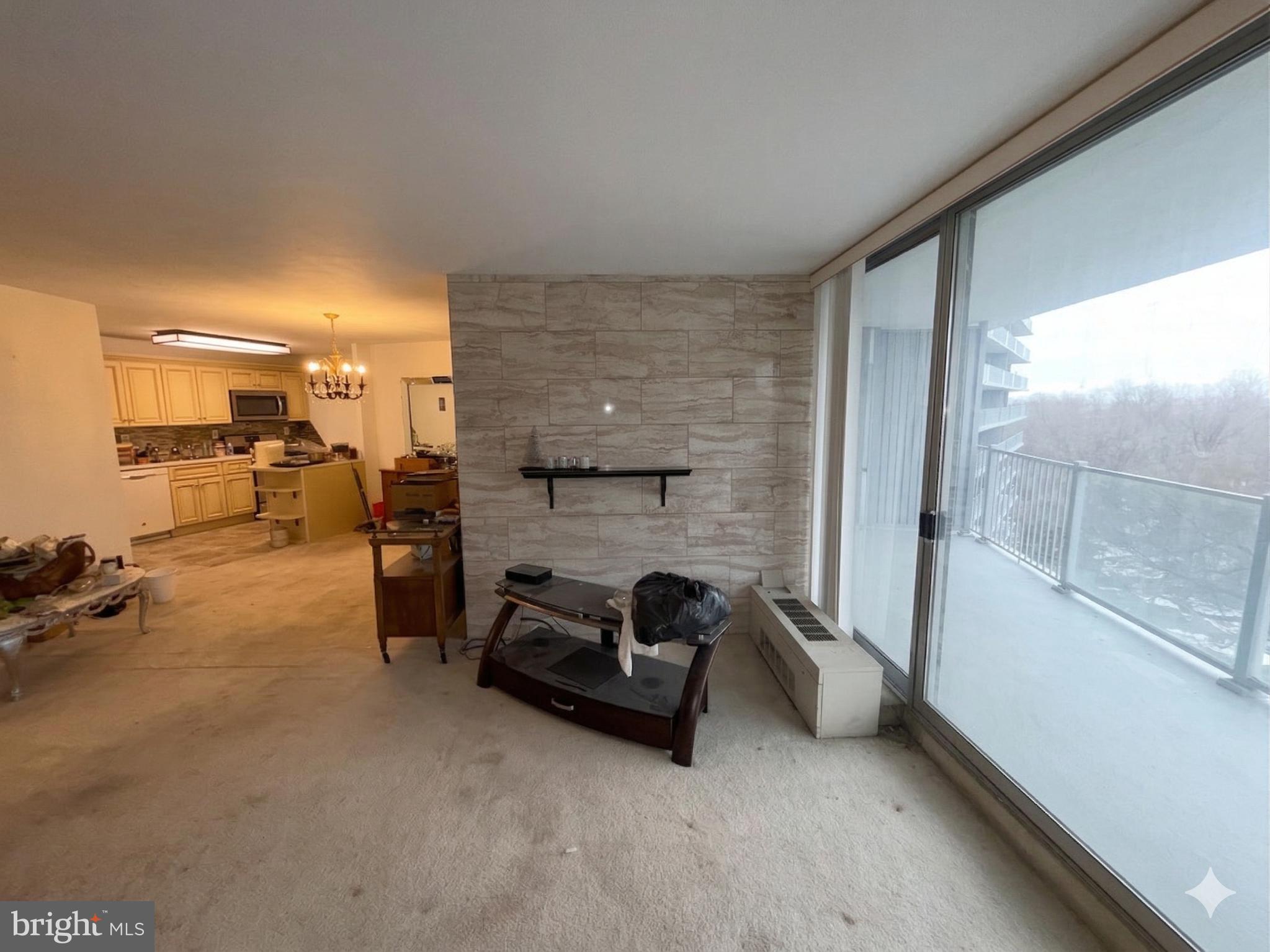 3900 West Ford Road, Unit 9K Philadelphia, PA 19131 - Photo 7 of 17 a living room with furniture and a fireplace