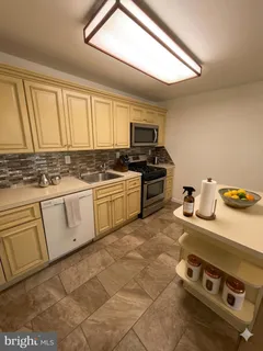 a kitchen with a stove a sink and a microwave