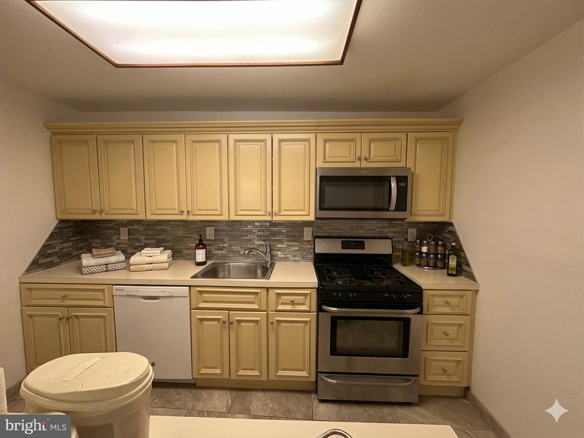 3900 West Ford Road, Unit 9K Philadelphia, PA 19131 - Photo 9 of 17 a kitchen with a stove and a microwave