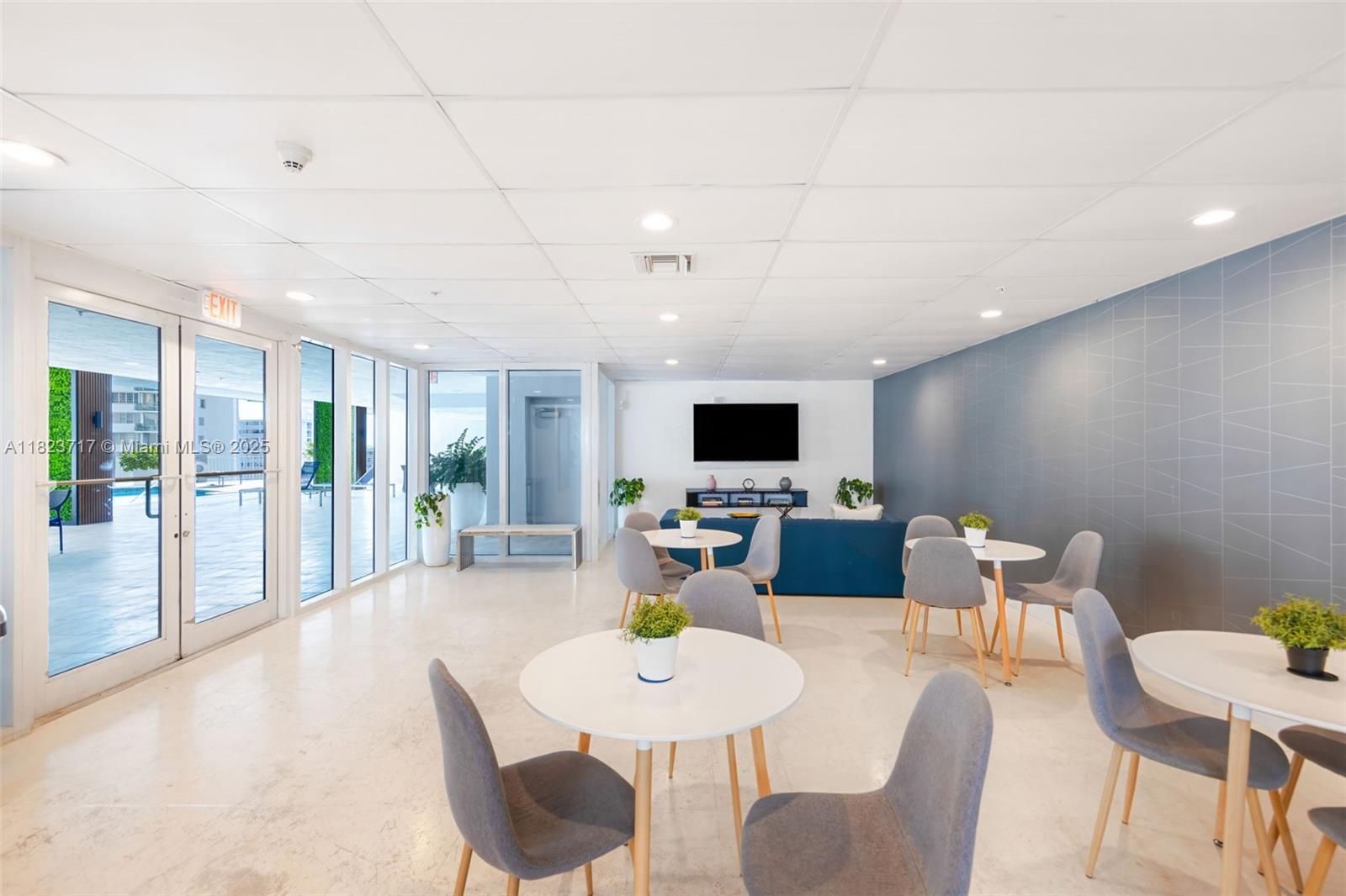 170 Southeast 14th Street, Unit 1203 Miami, FL 33131 - Photo 21 of 24 a living room with furniture a flat screen tv and a table