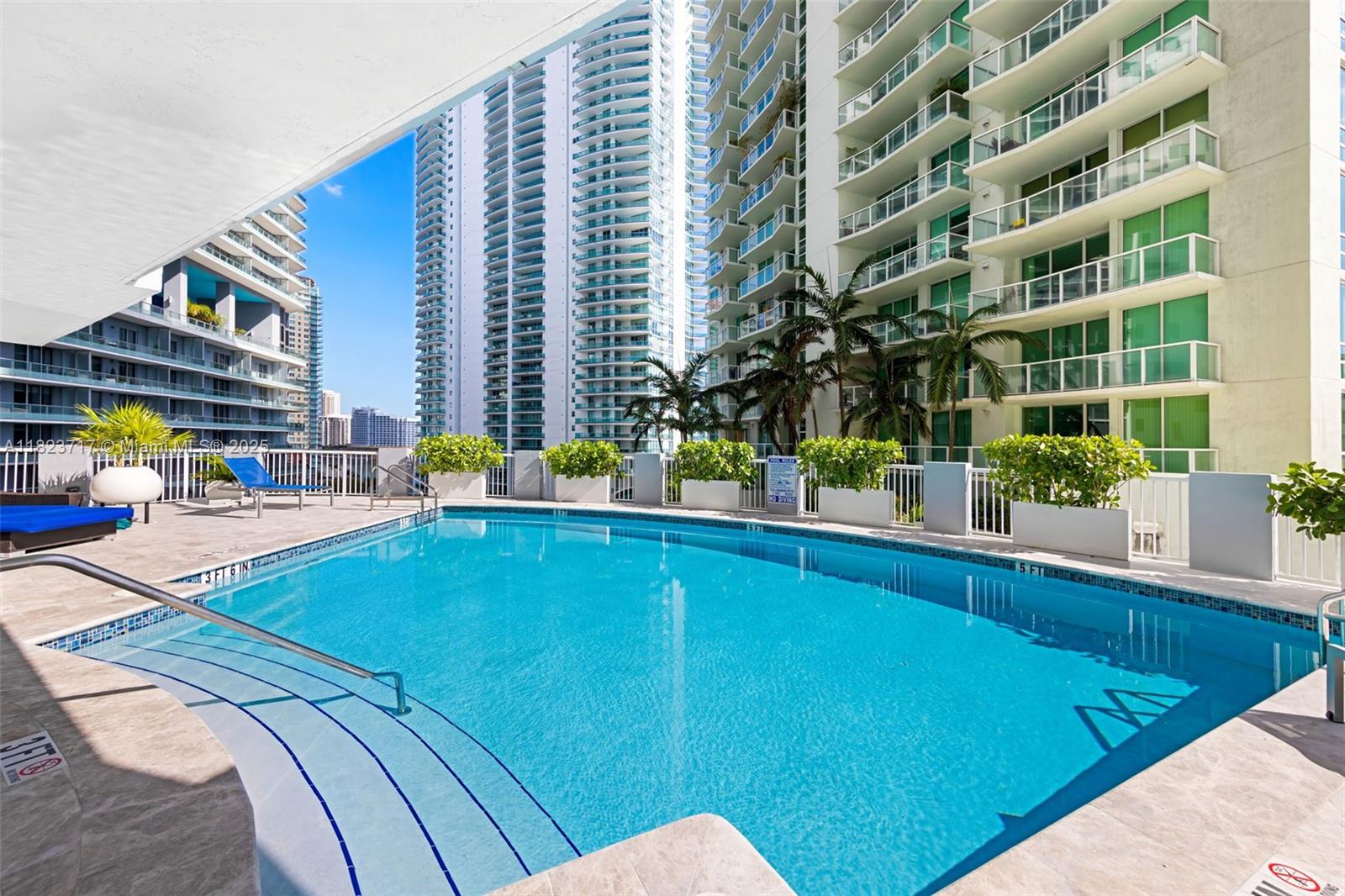 170 Southeast 14th Street, Unit 1203 Miami, FL 33131 - Photo 24 of 24 a view of a swimming pool with a lounge chairs