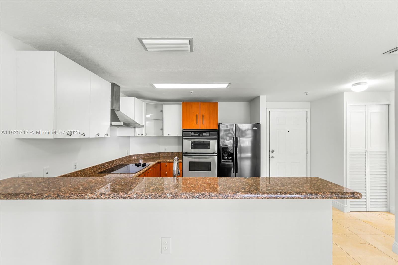 170 Southeast 14th Street, Unit 1203 Miami, FL 33131 - Photo 3 of 24 a kitchen with stainless steel appliances granite countertop a sink and a stove